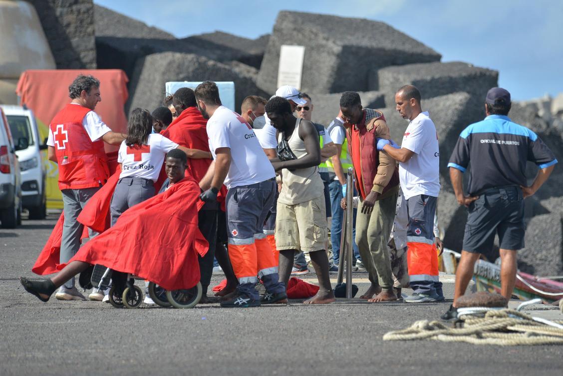 Members of the Red Cross tend to migrants disembarking from a boat at La Restinga dock, in the municipality of El Pinar on the Canary Island of El Hierro, on Oct. 31, 2023. (AFP)