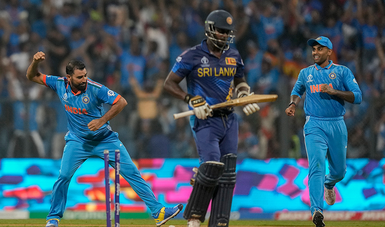 India's Mohammed Shami, left, celebrates the dismissal of Sri Lanka's Angelo Mathews, center, during the ICC Men's Cricket World Cup match between India and Sri Lanka in Mumbai, India, Thursday, Nov. 2, 2023. (AP)