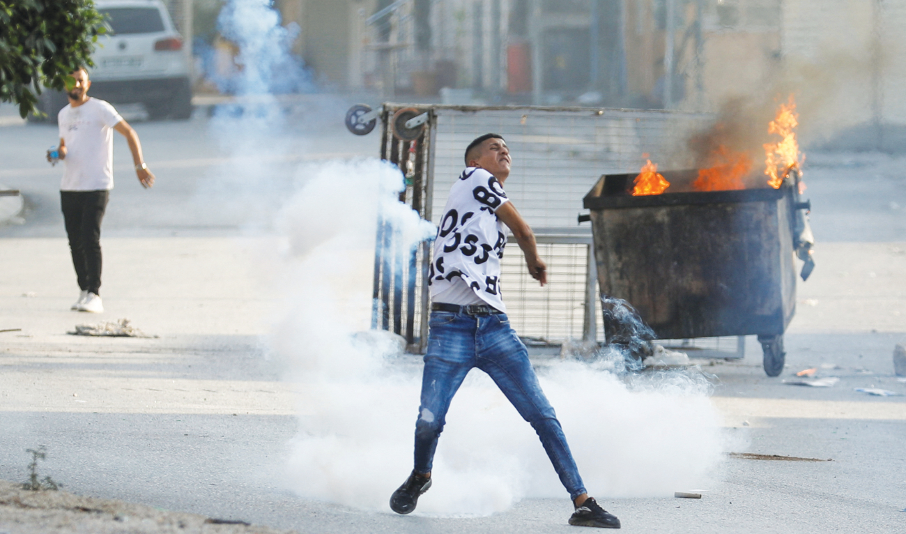 Palestinians clash with Israeli troops near Nablus in the Israeli-occupied West Bank on Thursday. (Reuters)