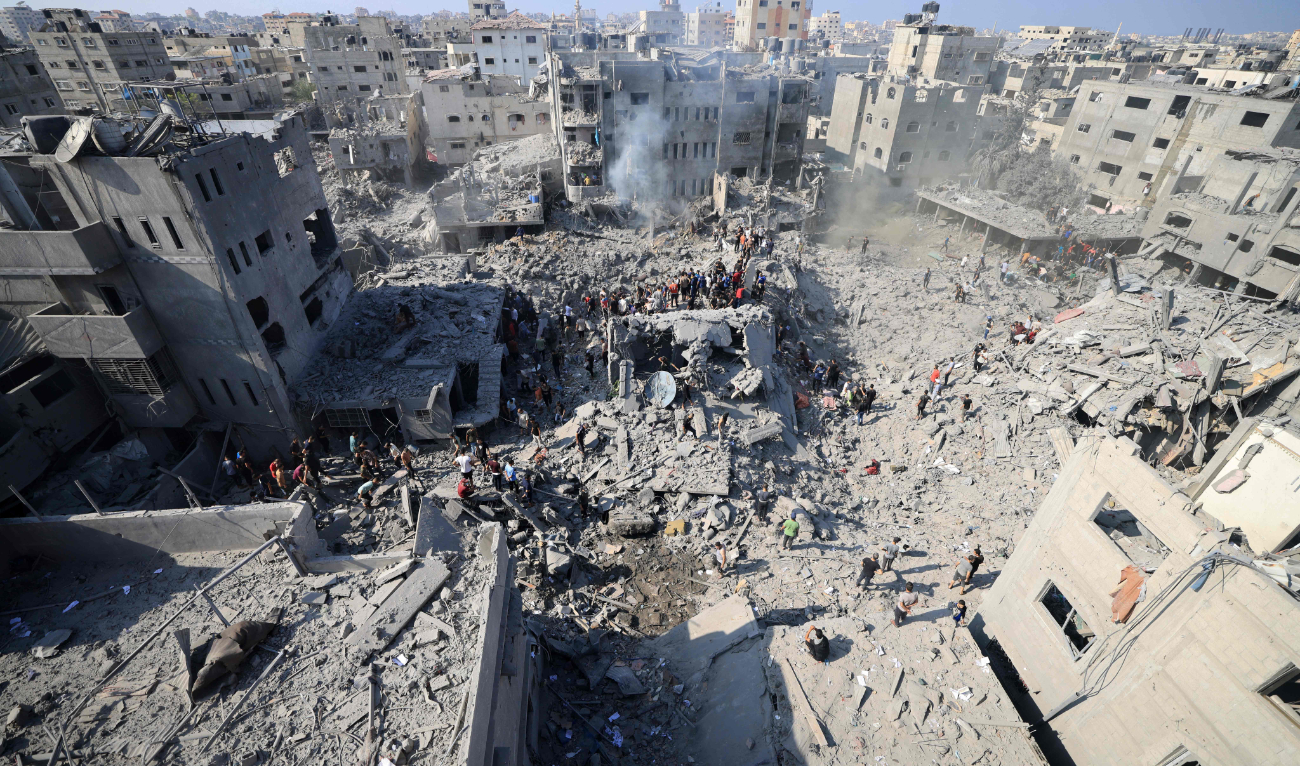 People check the rubble of buildings destroyed in an Israeli strike on the Bureij refugee camp in the central Gaza Strip on November 2, 2023, as battles between Israel and the Palestinian Hamas movement continue. (AFP)