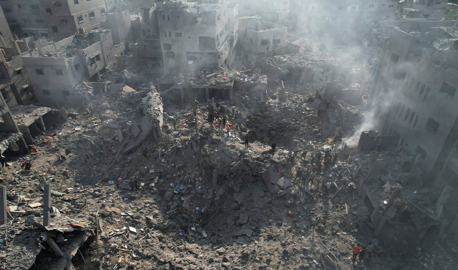 Palestinians gather at the site of Israeli strikes on houses in Bureij in the central Gaza Strip, on November 2, 2023. (REUTERS)