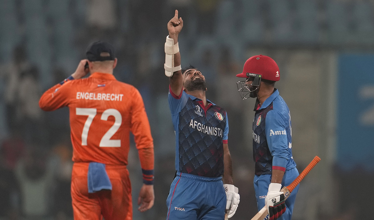 Afghanistan's captain Hashimatullah Shahidi and his teammate Azmatullah Omarzai celebrate after wining against Netherland by 7 wickets during the ICC Men's Cricket World Cup match in Lucknow, India, on November 3, 2023. (AP)