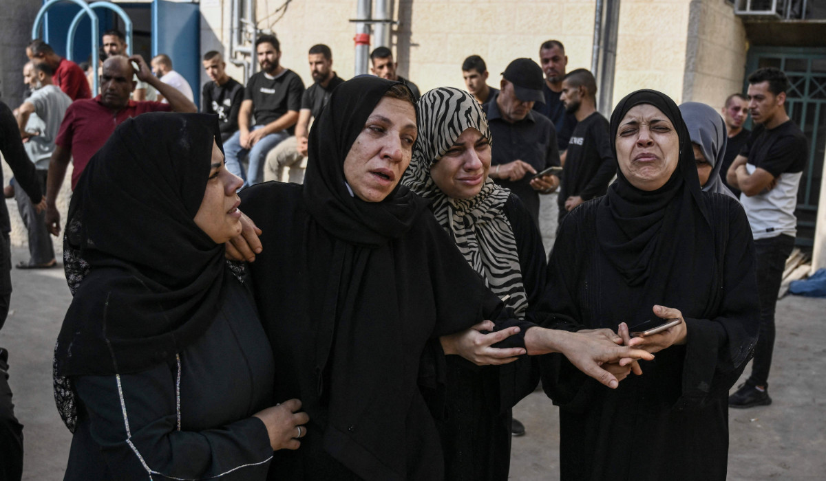 Palestinian relatives react outside the morgue of the Jenin Hospital on Friday before the funeral of a man killed during clashes with the Israeli army. (AFP)