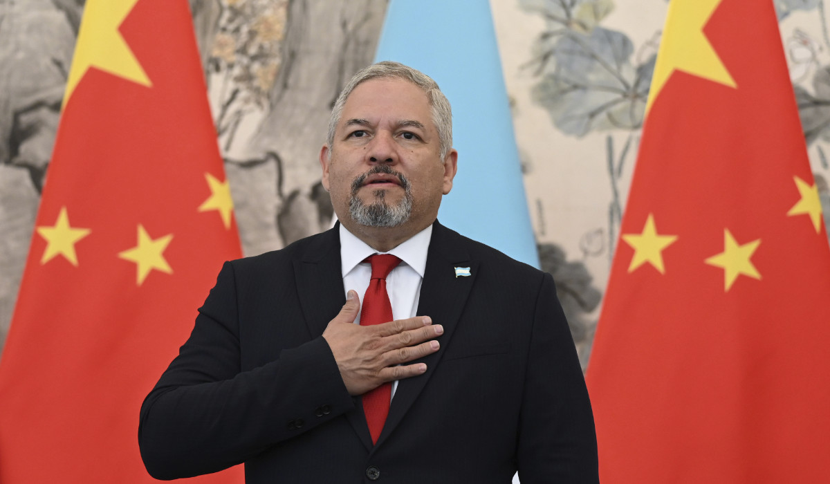 Foreign Minister Eduardo Enrique Reina of Honduras stands for the playing of national anthems during a ceremony in Beijing, March 26, 2023. (AP)