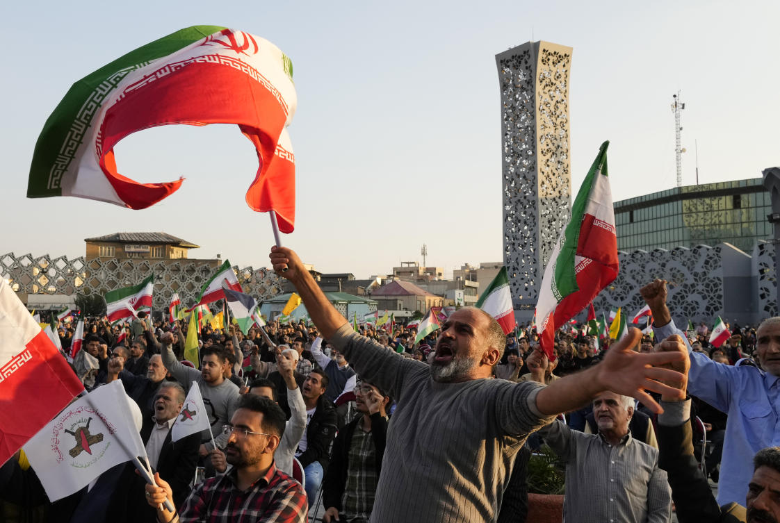 Iranian demonstrators wave Iranian and Palestinian flags during a pro-Palestinian rally in a downtown square in Tehran, Iran. (AP)