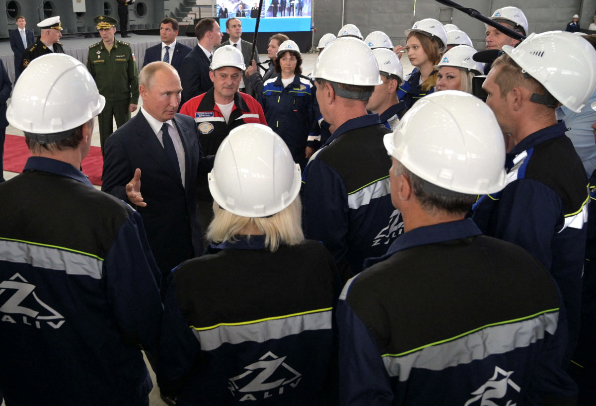 Russian President Vladimir Putin speaks with workers during a ceremony to mark the formal beginning of construction of Russian warships at Kerch's Zaliv shipyard on July 20, 2020. (Sputnik via AFP/File)