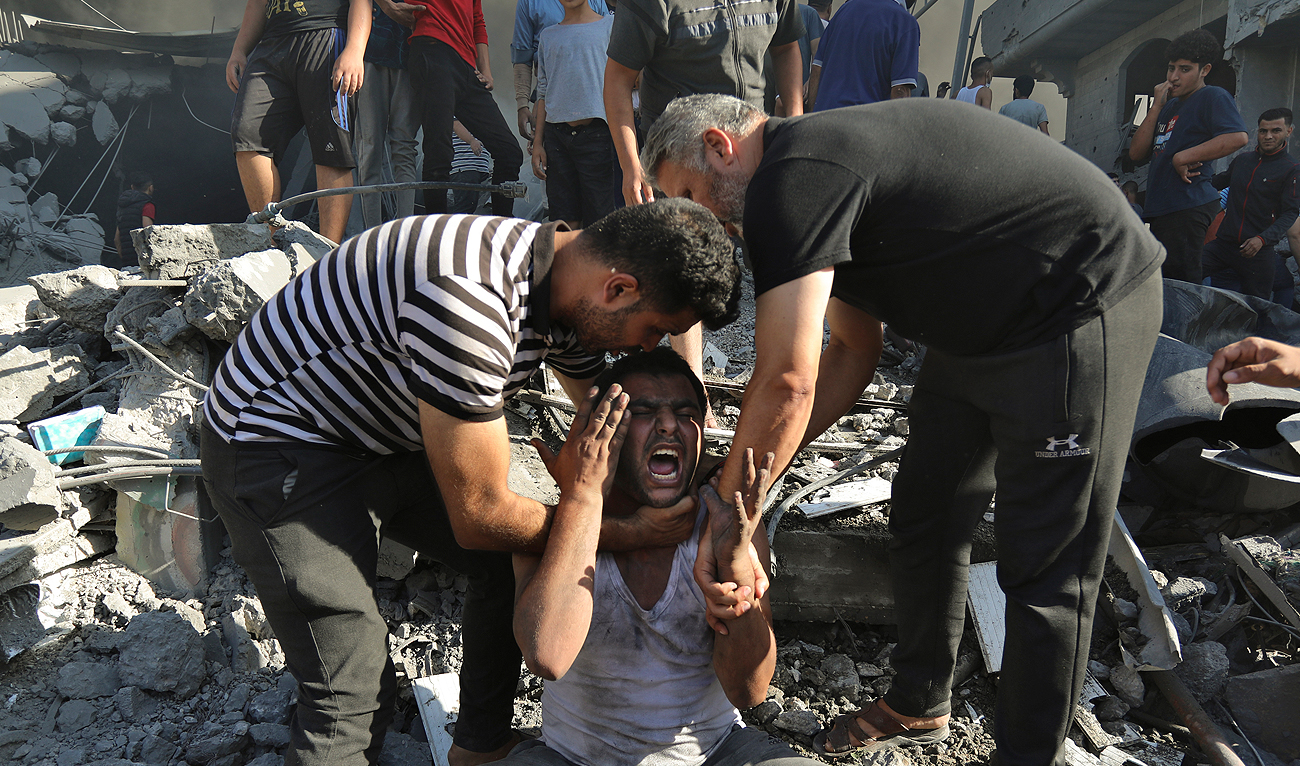 Palestinians comfort a crying man after losing relatives under the rubble of a destroyed house following an Israeli airstrike in Gaza City, Saturday, Nov. 4, 2023. (AP)