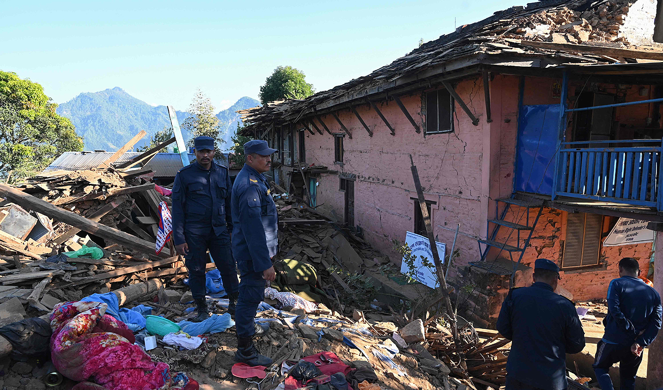 Nepali policemen inspect the rubble of houses in Jajarkot district on November 4, 2023, following an overnight a 5.6-magnitude earthquake. (AFP)