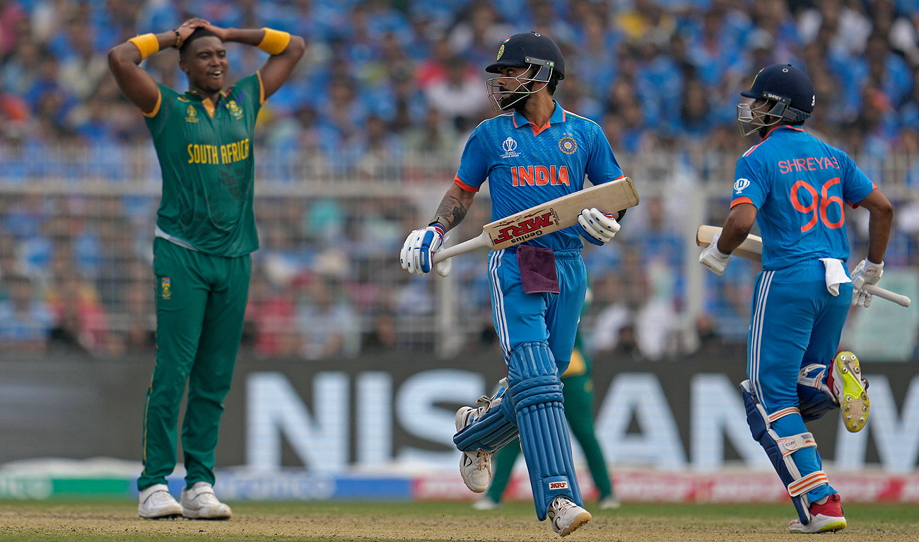 South Africa's Lungi Ngidi, left, reacts as India's Virat Kohli, center, and Shreyas Iyer run between the wickets to score during the ICC Men's Cricket World Cup match between India and South Africa in Kolkata, India, Sunday, Nov. 5, 2023. (AP)
