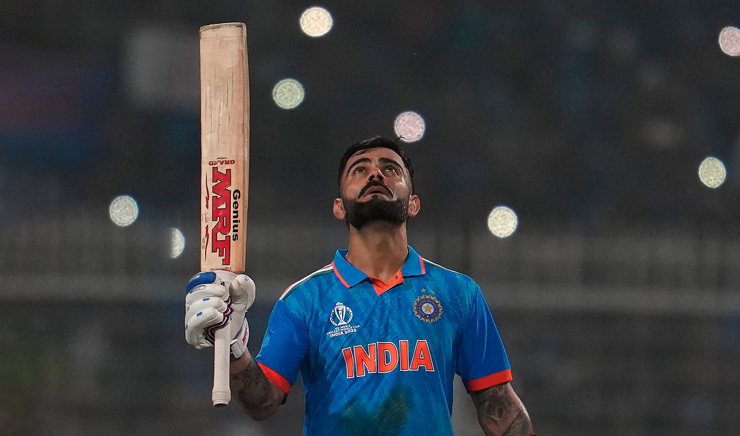 India's Virat Kohli looks skywards as he celebrates scoring a century during the ICC Men's Cricket World Cup match between India and South Africa in Kolkata, India, on November 5, 2023. (AP)
