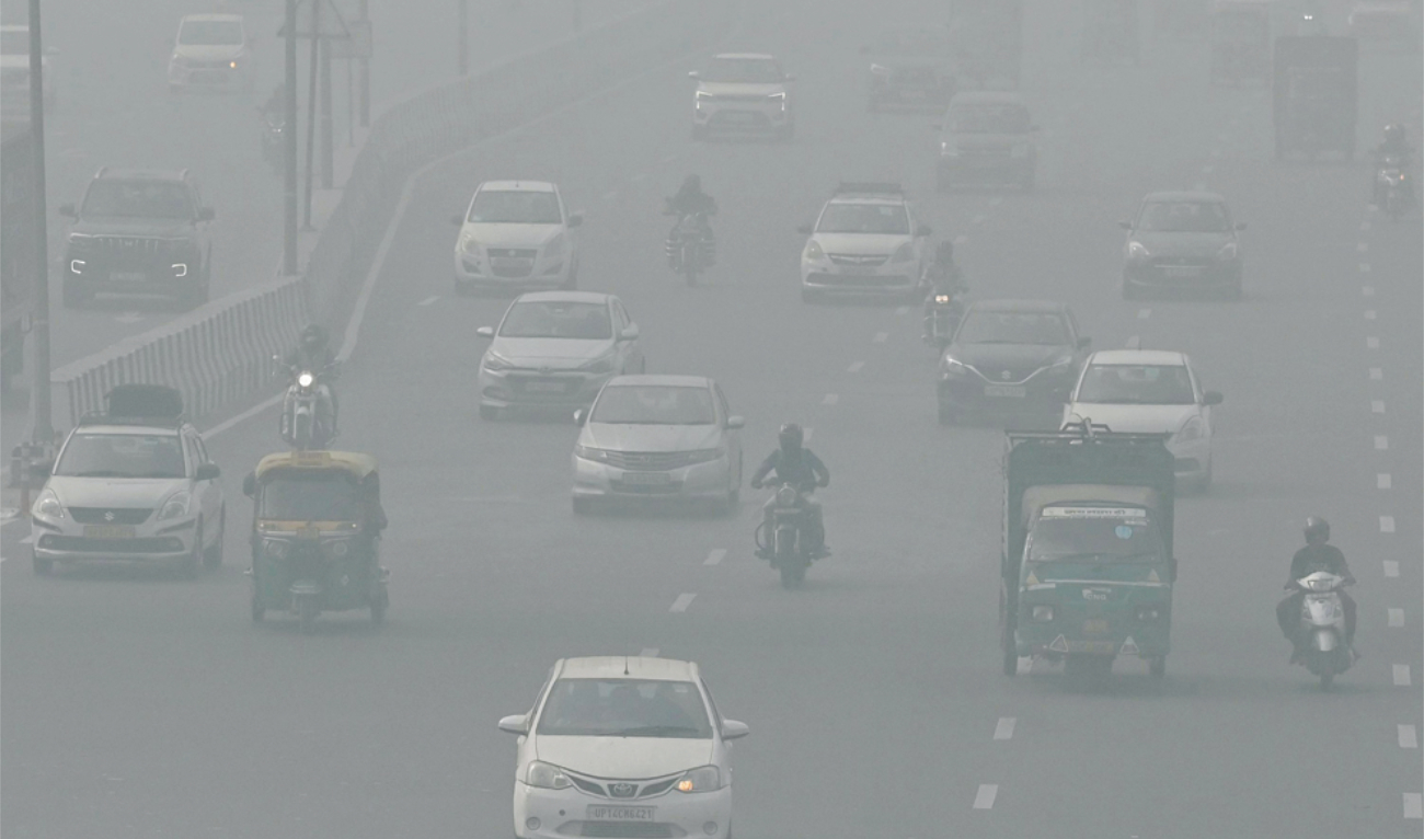 Commuters drive amid heavy smoggy conditions in New Delhi on Sunday. (AFP)