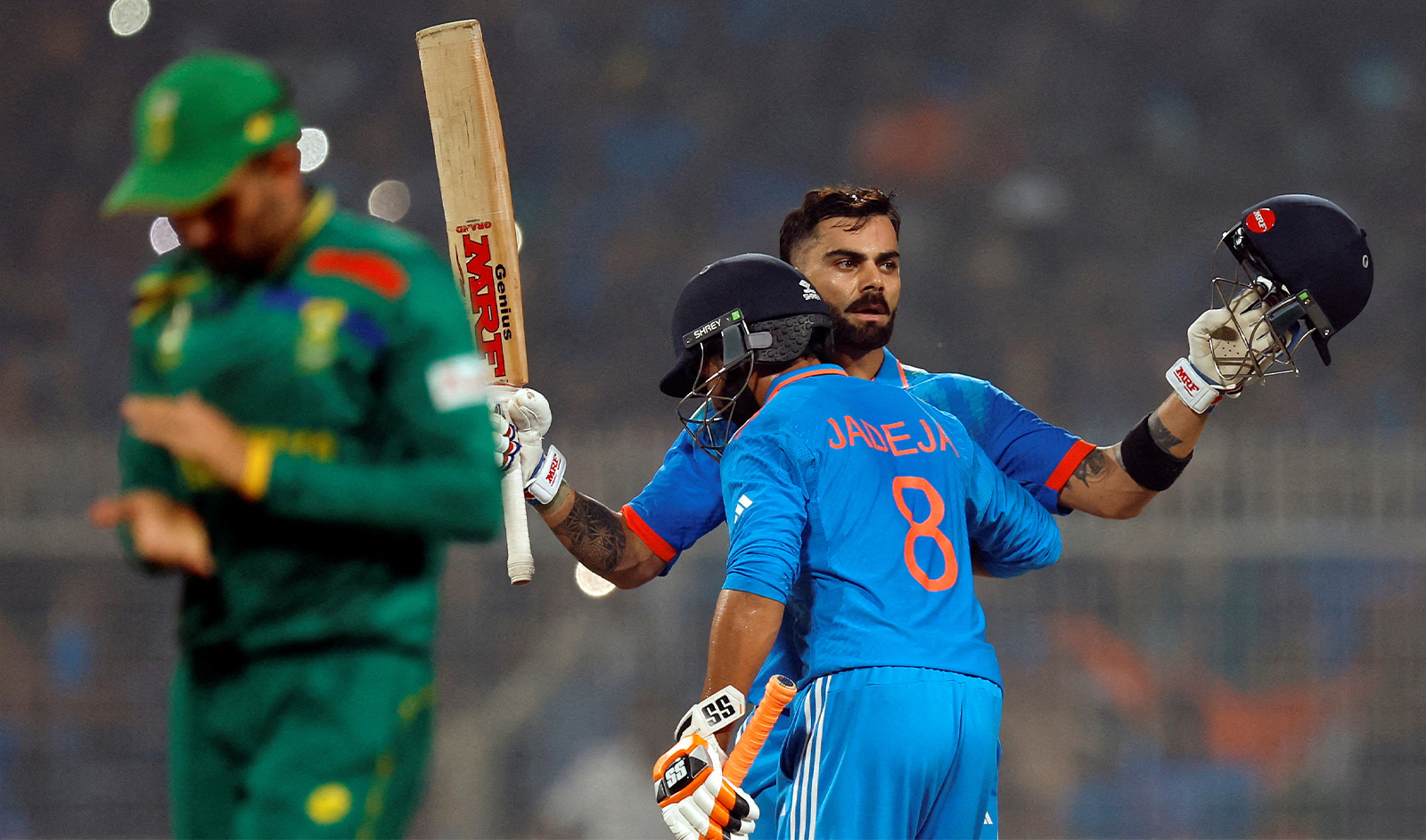India's Virat Kohli celebrates with Ravindra Jadeja after reaching his 49th century, equalizing with Sachin Tendulkar's record of most number of ODI centuries at Eden Gardens in Kolkata, India, on November 5, 2023. (REUTERS)