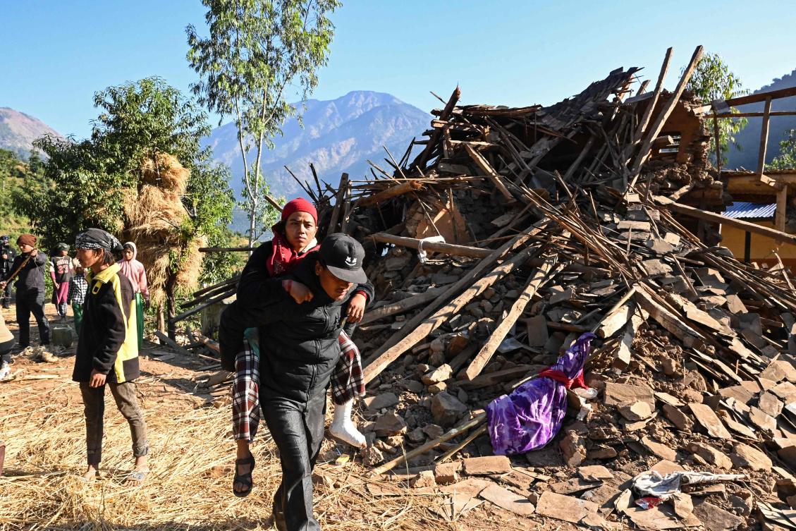 Survivors of a recent earthquake, walk past a damaged house in Chiuri village at Jajarkot district on November 5, 2023. (File/AFP)