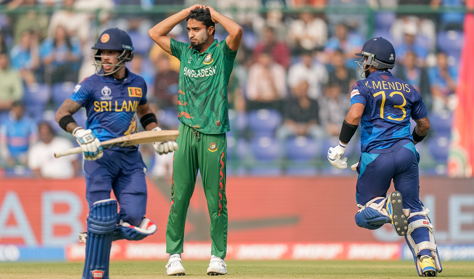 Bangladesh's Tandem Hasan Sakib, center, reacts as Sri Lanka's captain Kusal Mendis, right, and his batting partner Pathum Nissanka run between the wickets during the ICC Men's Cricket World Cup match between Bangladesh and Sri Lanka in New Delhi, India, on November 6, 2023. (AP)