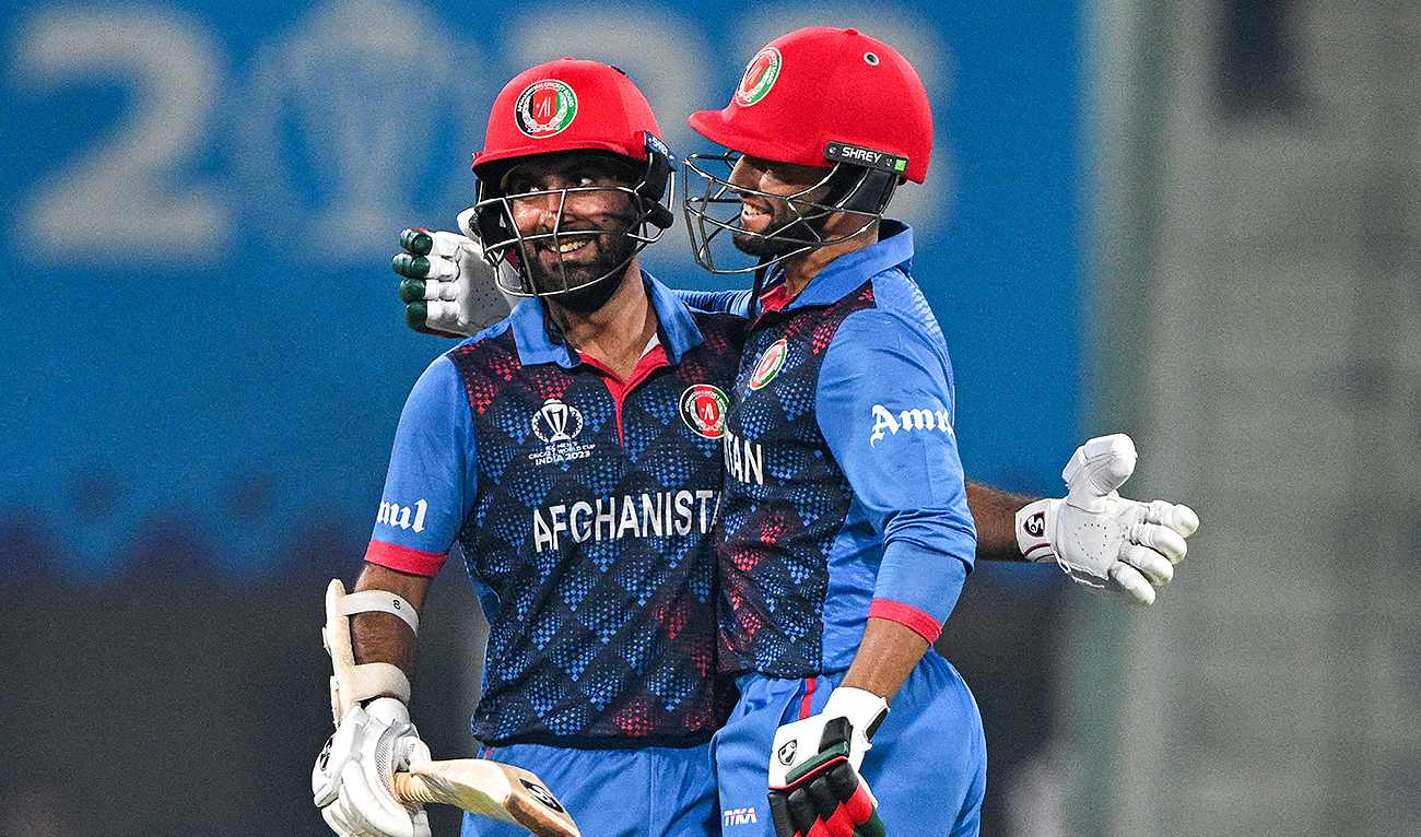 Afghanistan's captain Hashmatullah Shahidi (L) celebrates after scoring a half-century (50 runs) with Azmatullah Omarzai during the 2023 ICC Men's Cricket World Cup one-day international (ODI) match between Netherlands and Afghanistan at the Ekana Cricket Stadium in Lucknow on November 3, 2023. (AFP)