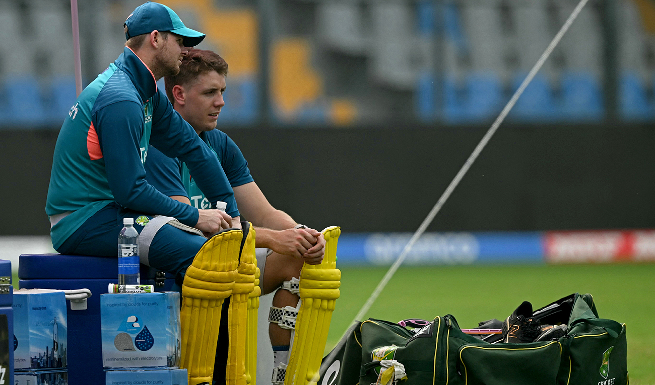 Australia's Steve Smith (L) and Cameron Green speak during a practice session on the eve of their 2023 ICC Men's Cricket World Cup one-day international (ODI) match against Afghanistan at the Wankhede Stadium in Mumbai on November 6, 2023. (AFP)