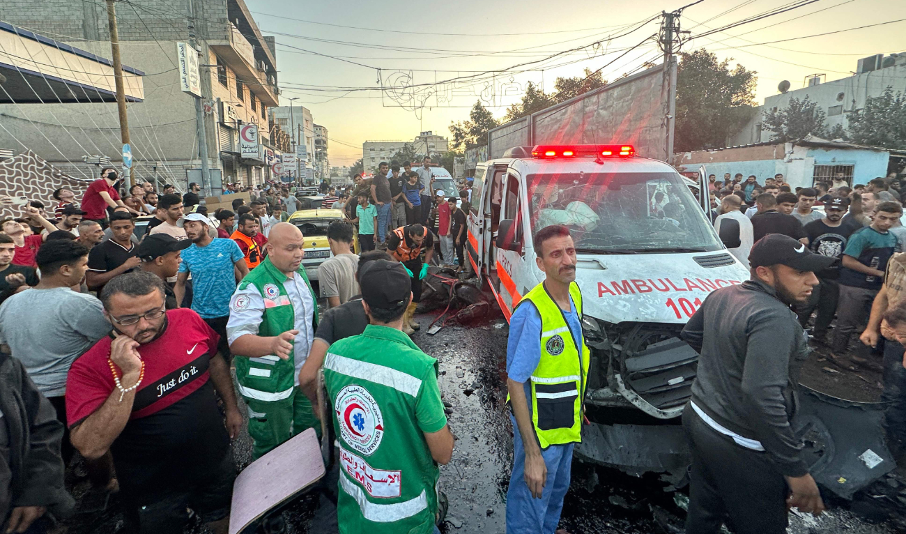 A dead horse lies on the ground as people gather around an ambulance damaged in a reported Israeli strike in front of Al-Shifa hospital in Gaza City on November 3, 2023, as battles between Israel and the Palestinian Hamas movement continue. (AFP/File)