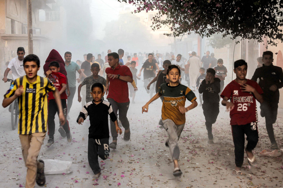 Palestinian children run as they flee from Israeli bombardment in Rafah in the southern Gaza Strip on November 6, 2023, amid continuing battles between Israel and the Palestinian militant group Hamas. (AFP)