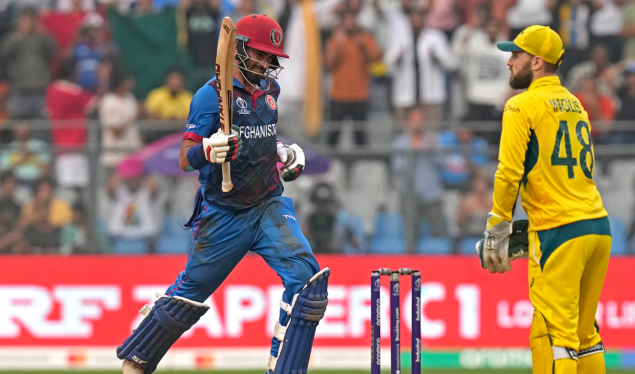 Afghanistan's Ibrahim Zardan, left, celebrates scoring a century during the ICC Men's Cricket World Cup match between Australia and Afghanistan in Mumbai, India, Tuesday, Nov. 7, 2023. (AP)
