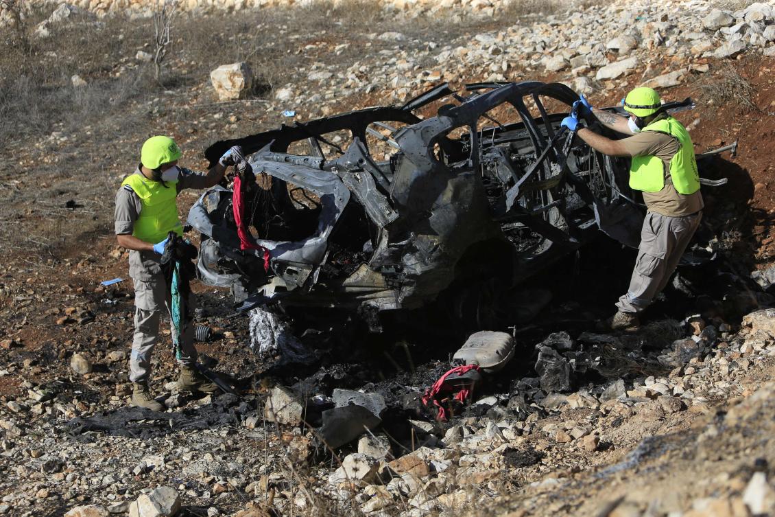 Rescuers from Hezbollah’s Islamic Sanitary committee inspect the wreckage of a vehicle in which civilians were killed during an Israeli strike in southern Lebanon near the border with Israel, on Nov. 6, 2023. (AFP)