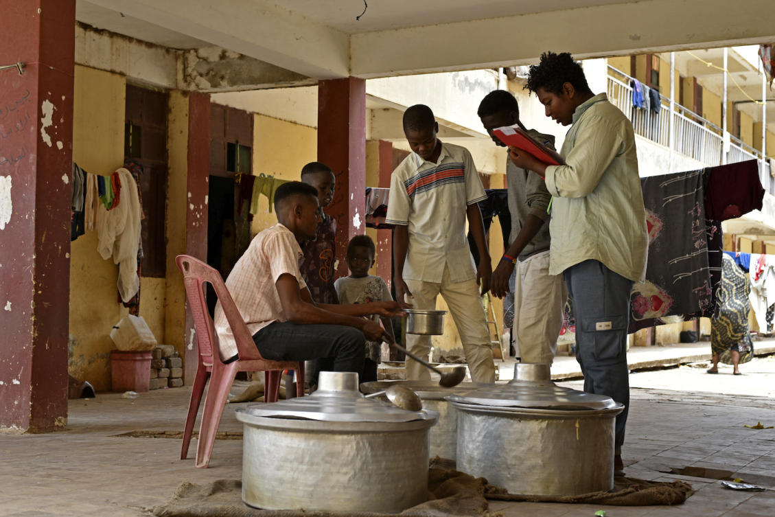 Volunteers from a charitable organisation distribute food to internally displaced people at a camp in Wad Madani, the capital of Al-Jazirah state, Sudan. (File/AFP)