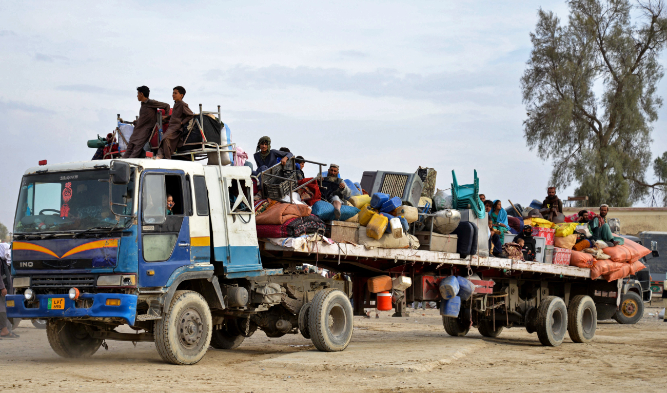 Afghan refugees with their belongings arrive on a truck from Pakistan, at a registration center near the Afghanistan-Pakistan border in the Spin Boldak district of Kandahar province on November 6, 2023. (AFP)
