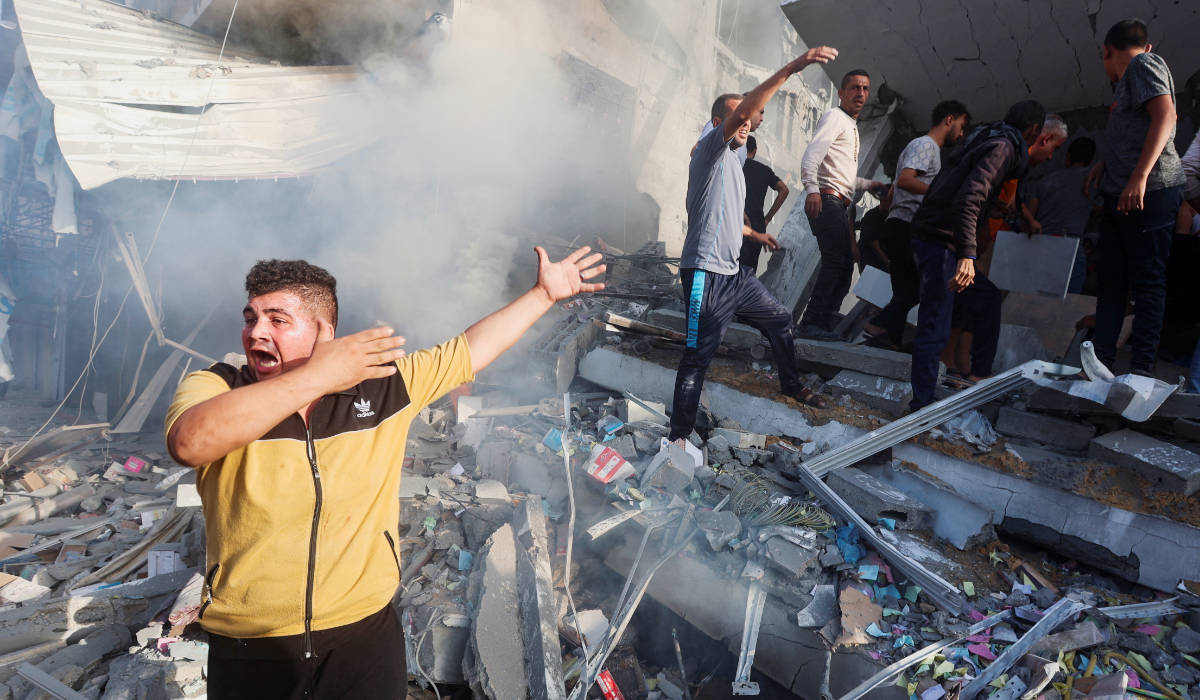Palestinians react at the site of Israeli strikes on a residential building, amid the ongoing conflict between Israel and Palestinian Islamist group Hamas, in Khan Younis in the southern Gaza Strip, November 7, 2023. (REUTERS)