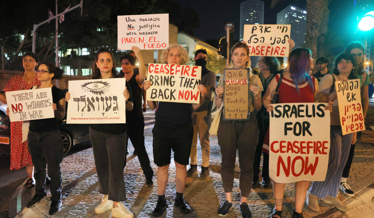 Israeli left-wing activists hold placards and chant slogans during a demonstration against the war with Gaza in Tel Aviv on November 4, 2023. (AFP)