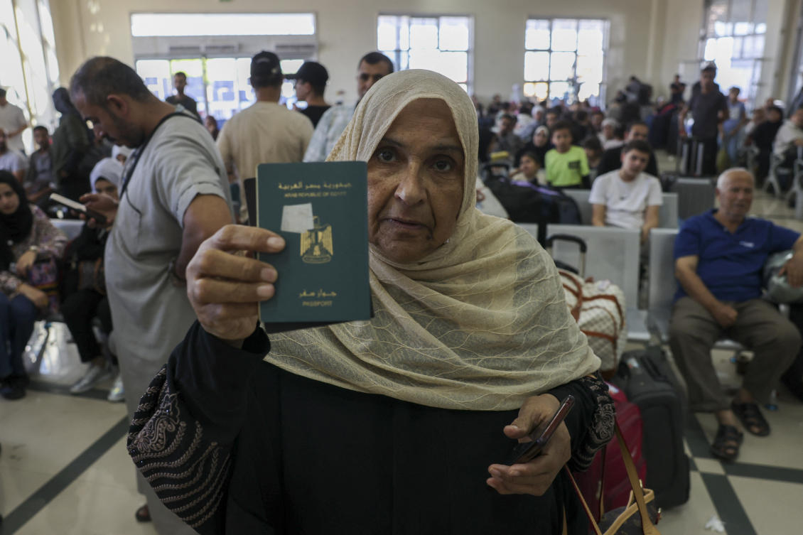 Palestinian dual nationals and foreigners have been waiting to cross the Rafah border crossing with Egypt, in the southern Gaza Strip. (AFP)