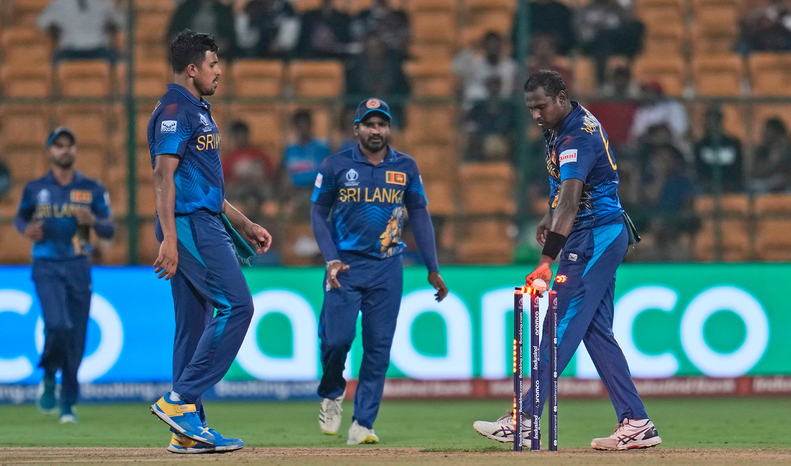 Sri Lanka's Kasun Rajitha takes off the bails to run out New Zealand's Mark Chapman during the ICC Men's Cricket World Cup match between New Zealand and Sri Lanka in Bengaluru, India, on November 9, 2023. (AP)