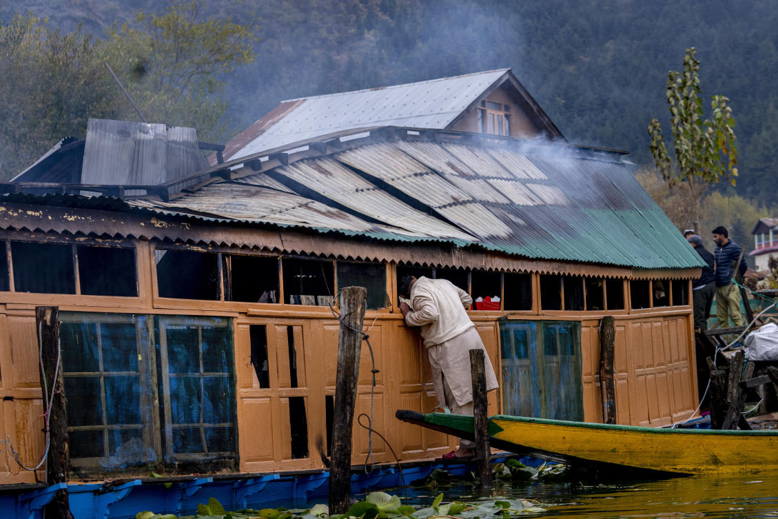A Kashmiri inspects the damage after a fire gutted several houseboats early morning in the interiors of Dal Lake, on the outskirts of Srinagar, Indian controlled Kashmir, on Nov. 11, 2023. (AP)