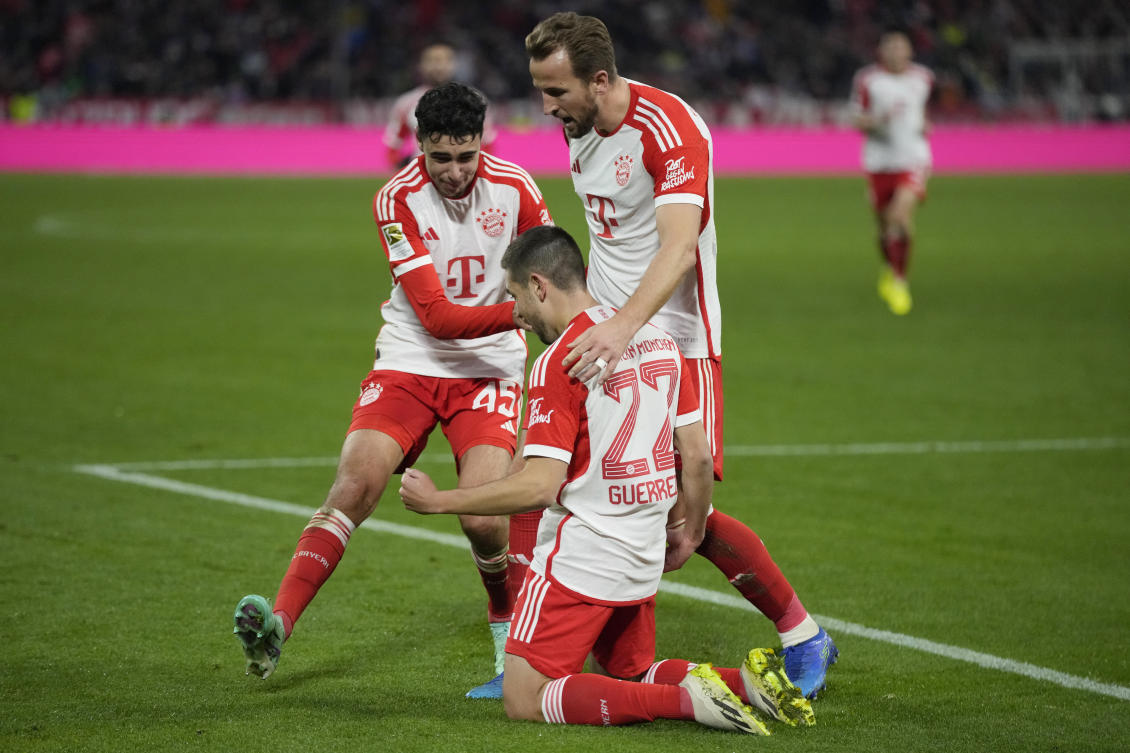 Bayern’s Raphael Guerreiro celebrates with his teammates Harry Kane and Alexander Pavlovic after scoring his side’s third goal during their Bundesliga match against Heidenheim at the Allianz Arena in Munich on Nov. 11, 2023. (AP)