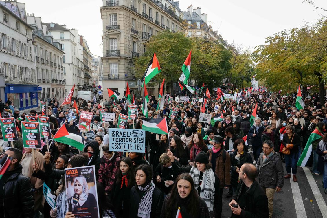 Protesters, holding a placard which reads as “Gaza, Paris stands with you! Israel, terrorists! Cease fire” (C), take part in a demonstration to demand an immediate cease-fire in Gaza near Place de la Republique in Paris, on Nov. 11, 2023. (AFP)