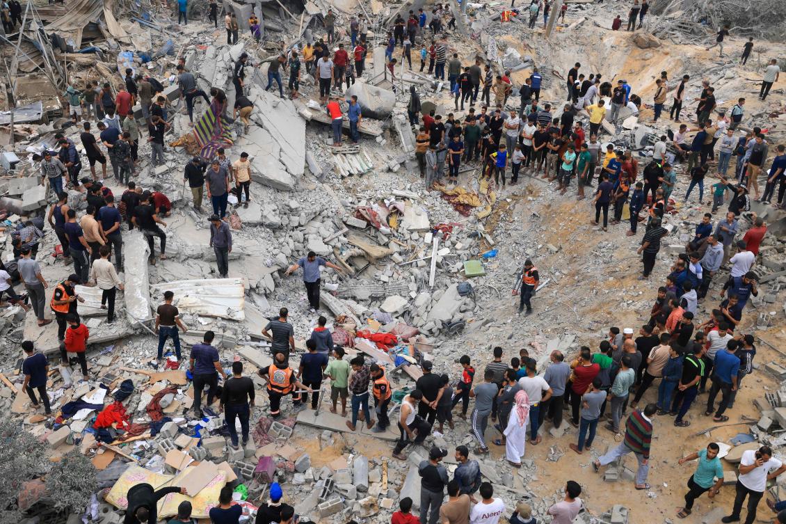 Civilians and rescuers look for survivors amid the rubble of a destroyed building following an Israeli bombardment in Khan Yunis in the southern Gaza Strip on November 12, 2023.(AFP)