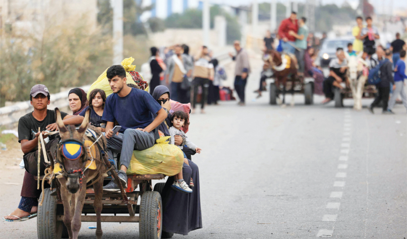 Palestinians arrive south of Gaza City on Sunday after fleeing their homes amid the ongoing battles between Israel and Hamas. (AFP)