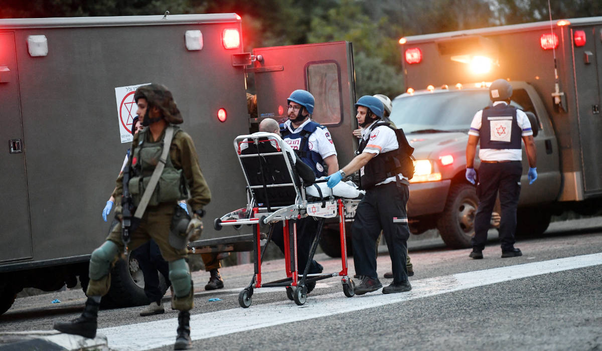 Israeli medics treat an injured man following anti-tank missiles that were fired from Lebanon towards Israel near the Israel-Lebanon border, and hit a number of civilians, the Israeli military said November 12, 2023 (REUTERS)