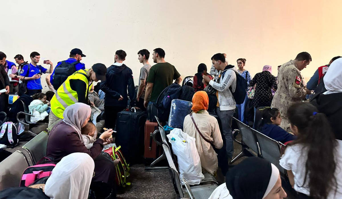 Passengers fleeing from the Gaza Strip arrive in the Egyptian part of the Rafah border crossing with the Palestinian enclave on November 12, 2023, amid the ongoing battles between Israel and the militant group Hamas. (AFP)