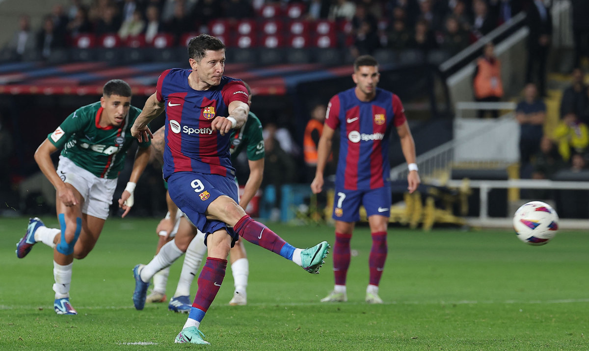 Barcelona's Polish forward Robert Lewandowski kicks from the penalty spot and scores his team's second goal during their Spanish league football match against Deportivo Alaves at the Estadi Olimpic Lluis Companys in Barcelona on Sunday. (AFP)