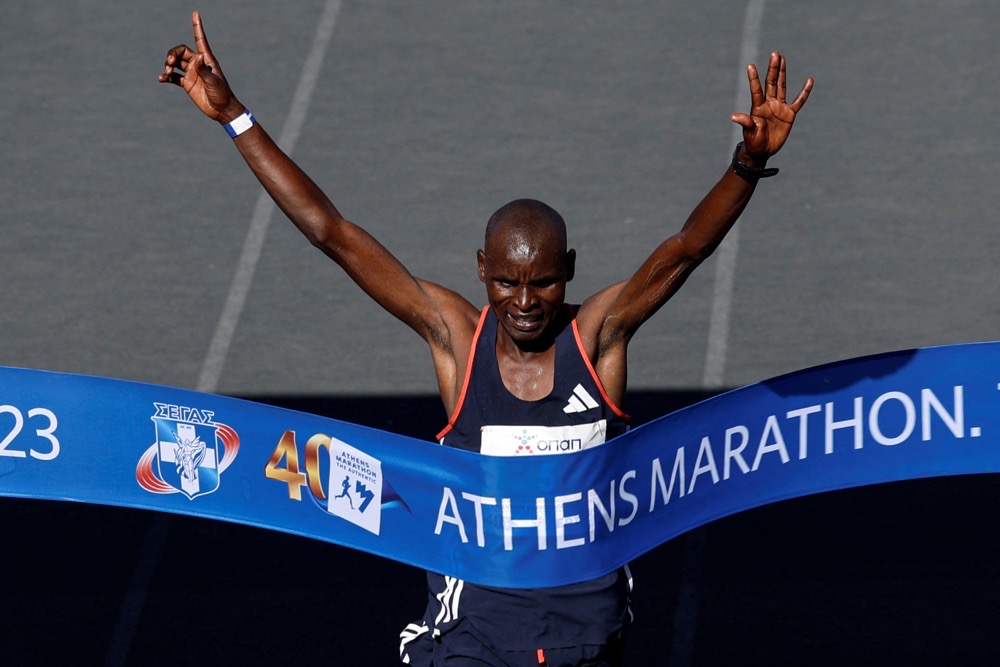 Kenyan long-distance runner Edwin Kiprop Kiptoo crosses the finish line to win the 40th Athens Marathon race, at the Panathenaic Stadium in Athens, Sunday. (Reuters)