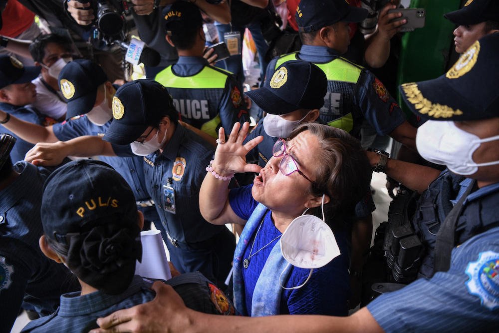 Former Philippine senator Leila de Lima, center, is accused of taking money from drug lords jailed inside the country’s largest prison to allow them to sell drugs while she was the justice minister from 2010 to 2015. (AFP)