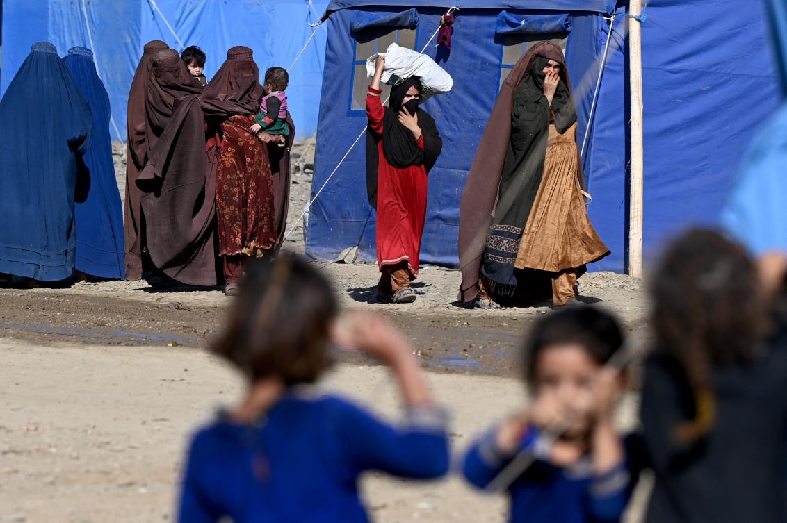Afghan refugees walk through a makeshift camp upon their arrival from Pakistan, near the Afghanistan-Pakistan Torkham border in Nangarhar province on Nov. 12, 2023. Currently, about 15,000 Afghans have been crossing the border every day from Pakistan. (AFP)
