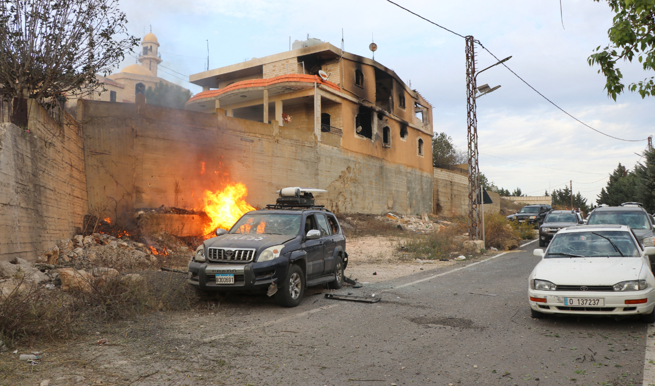 Flames erupt next to a press car following reported Israeli shelling in Lebanon’s southern border village of Yaroun on November 13, 2023, amid increasing cross-border tensions between Hezbollah and Israel. (AFP/File)
