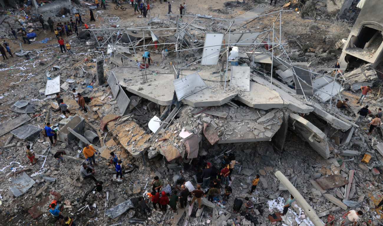 This aerial picture shows people gathered around a destroyed building following Israeli bombing on Rafah in the southern Gaza Strip, on November 11, 2023, as battles between Israel and the Palestinian Hamas movement continue. (AFP/File)