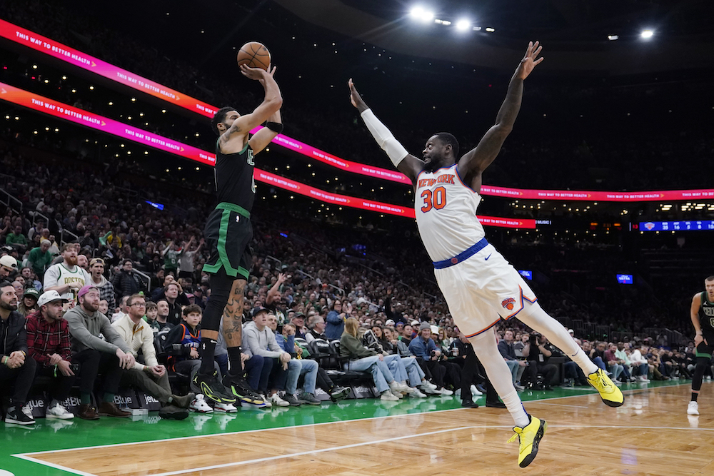 Boston Celtics forward Jayson Tatum, left, takes a shot over New York Knicks forward Julius Randle during the second half of an NBA basketball game Monday in Boston. (AP)