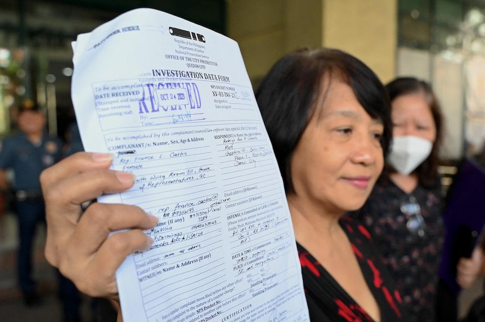 Leftist legislator France Castro shows a document after filing a criminal complaint against former Philippine president Rodrigo Duterte on Oct. 24, 2023. (AFP)