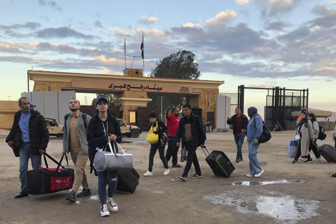 Palestinians with European passports who were evacuated from Gaza sit cross the Rafah border crossing in Egypt on Nov. 15, 2023. (AP)