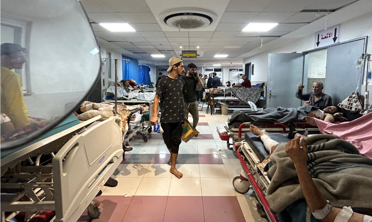 Men walk as patients rest at Al-Shifa hospital in Gaza City on November 10, 2023, amid ongoing battles between Israel and the Palestinian Hamas movement. (AFP)