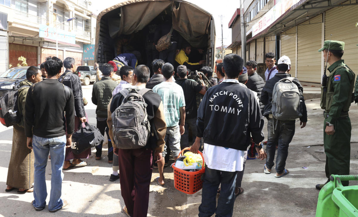 Above, members of the Myanmar National Democratic Alliance Army herd soldiers of the army battalion and their family members who surrendered to them in this Nov. 14, 2023 photo. (The Kokang online media via AP)