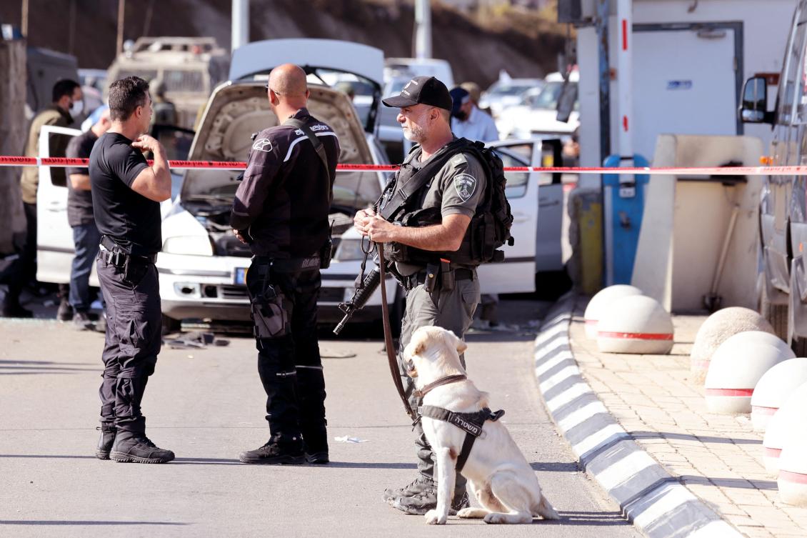 Israeli officers secure scene after attack by gunmen on a checkpoint guarding access to road tunnels linking the Israeli occupied Palestinian West Bank and Jerusalem. (AFP)