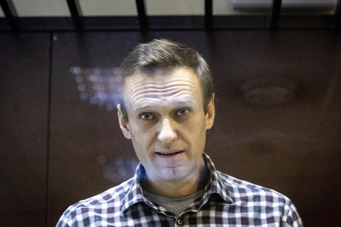 Russian opposition leader Alexei Navalny looks at photographers from inside a glass cage in the Babuskinsky District Court in Moscow, Russia, in February 2021. (AP/File)